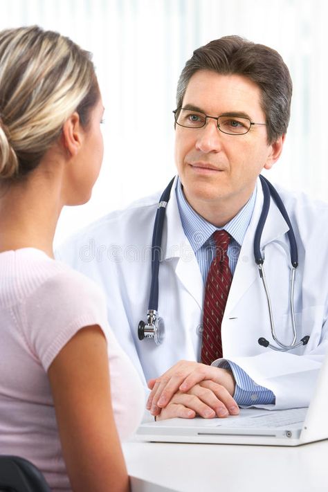 Doctor consulting with a female patient in a consulting room